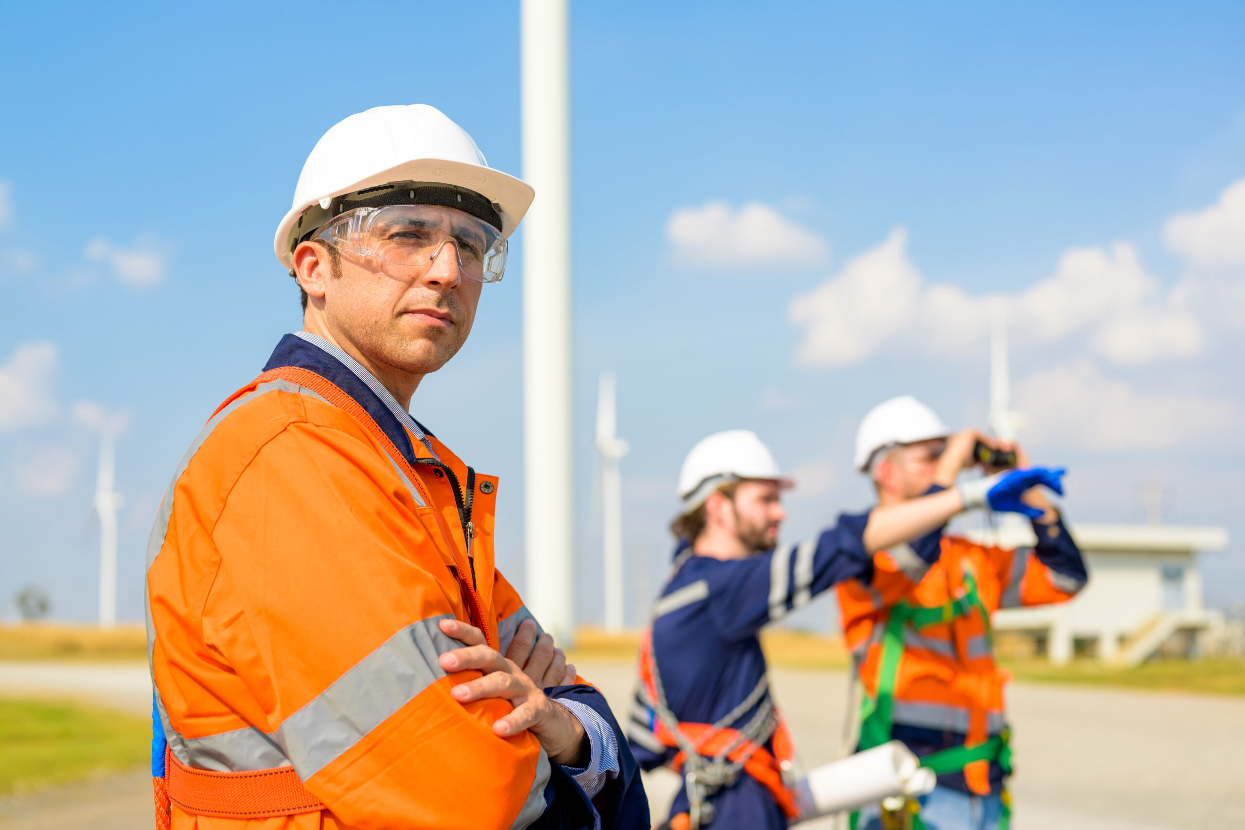 Renewable energy engineer working on wind turbine Technician working outdoor at wind turbine field. Environmental engineer research and develop approaches to providing clean energy sources